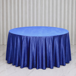 Round table with royal blue satin tablecloth in elegant event setting