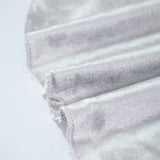 White pleated fabric close-up with soft texture and frayed edges