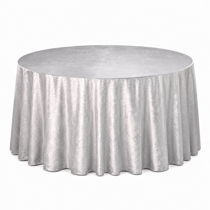 Silver round table with floor-length shimmering tablecloth on white background