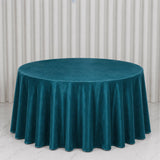 Teal round velvet tablecloth on elegant dining table backdrop