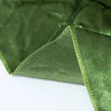 Green velvet fabric close-up with stitched seam and soft texture