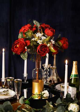 Table centerpiece with red flowers and candles