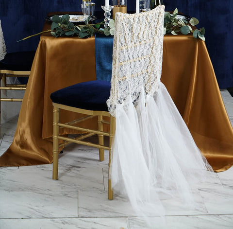 Close-up of candles, champagne, and greenery on the table