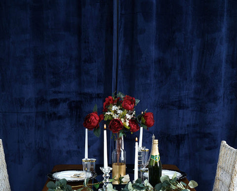 Table with gold cloth, navy runner, and lace chair drape