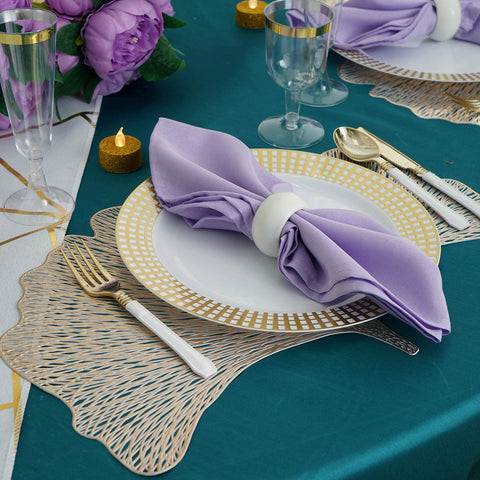 Close-up of lavender napkin on gold-rimmed plate