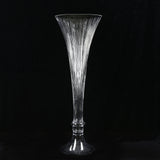 Tall clear glass vase with fluted ribbed design on black background