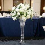 Elegant white floral centerpiece in tall glass vase at banquet table
