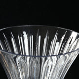 Close-up of a crystal glass bowl with faceted cut pattern on black background