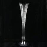 Tall clear fluted glass vase on black background