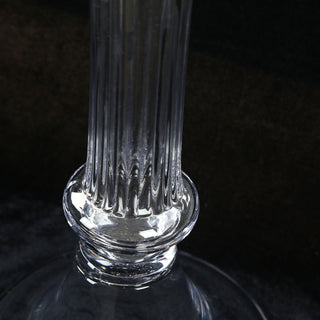 Close-up of clear glass bottle neck on a black background