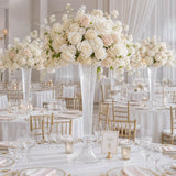 Elegant white and blush wedding reception table with tall floral centerpieces