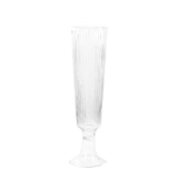 Textured clear champagne flute with a tall stem and ribbed design #whtbkgd