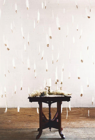 White feather garland hanging above a table