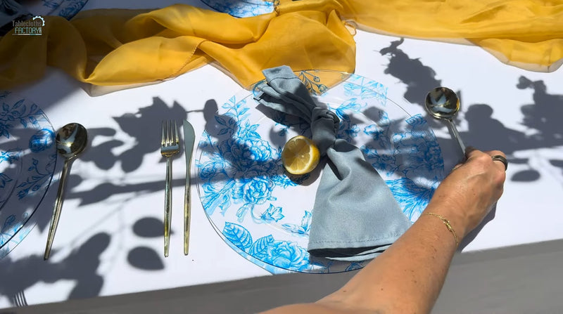 Amalfi Coast summer table setup with utensils and a lemon on the plate.