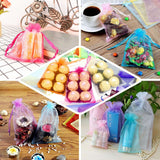 Colorful organza gift bags filled with chocolates and decorative items.