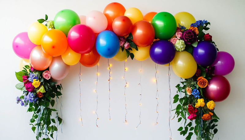 Colorful balloon arch with flowers and fairy lights
