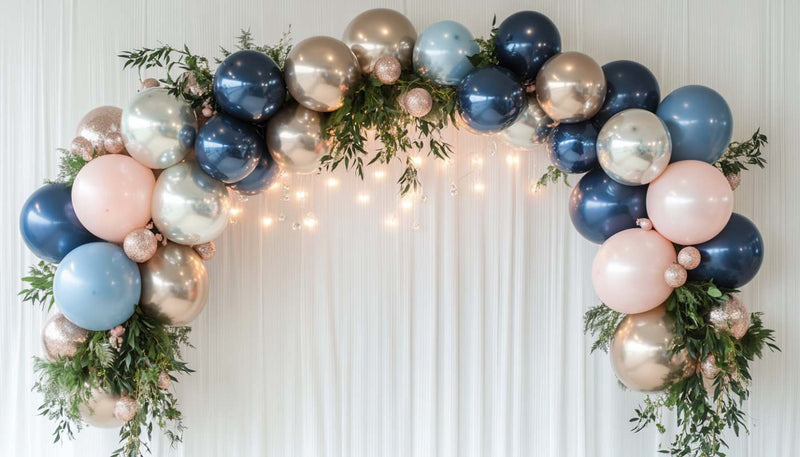 Navy and gold balloon arch with greenery and lights