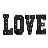 Black marquee letters spelling LOVE with lit bulbs on white background#whtbkgd
