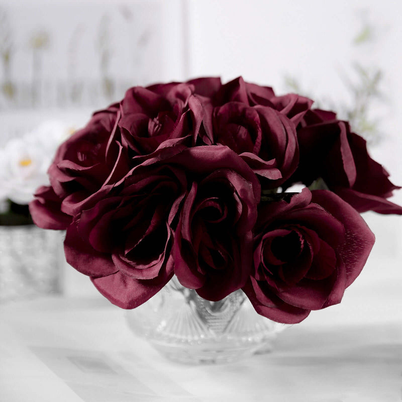 Burgundy artificial rose bouquet in a glass vase