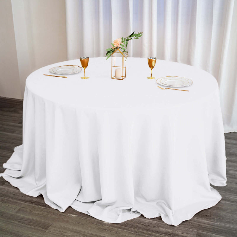 White round tablecloth with place settings and centerpiece