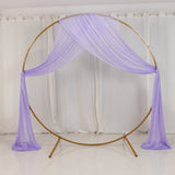Gold metal wedding arch with sheer lavender drapes