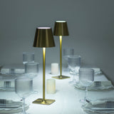 Elegant table setting with modern lamps and glassware.