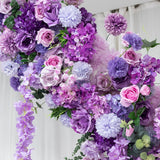 Purple floral arrangement with roses, hydrangeas, and other blooms. #whtbkgd