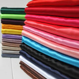 Colorful fabric swatches stacked in a neat arrangement for textile selection.