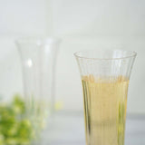 12 Pack | 6oz Gold Glitter Sprinkled Clear Plastic Champagne Flutes, Disposable Flared Glasses