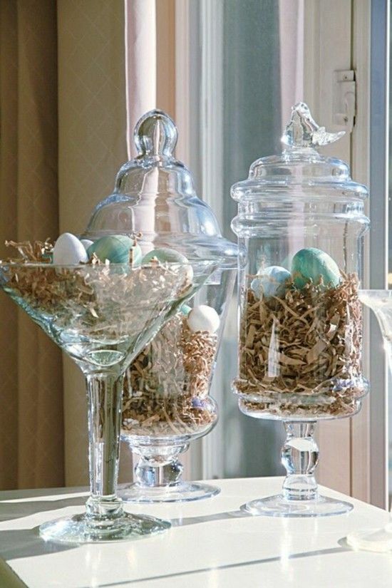 Glass jars filled with Easter grass and pastel eggs