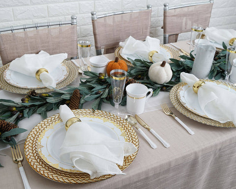 Fall table setting with olive garland and pinecones