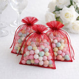 Colorful candy-filled organza bags in red, perfect for party favors.