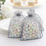 Pastel candy-filled favor bags with sheer gray pouches.
