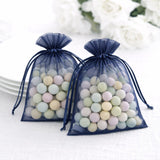 Navy organza bags filled with pastel candies on a light background.