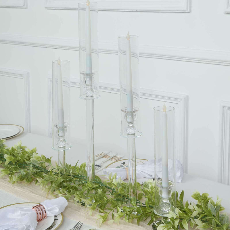 Clear glass candle holders with tall white taper candles