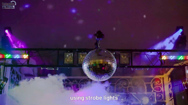 Disco ball with purple and green strobe lights, creating a smoky, club-like atmosphere.