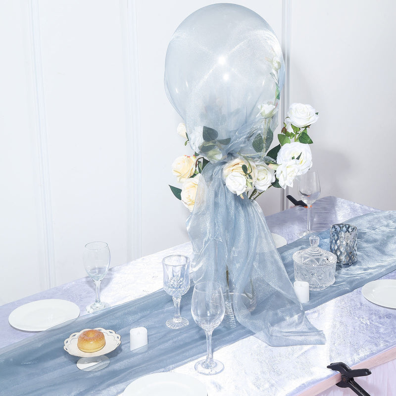 Light blue wedding arch draped with flowers