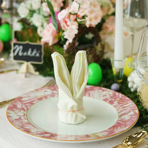 Close-up of a folded bunny napkin on a patterned plate