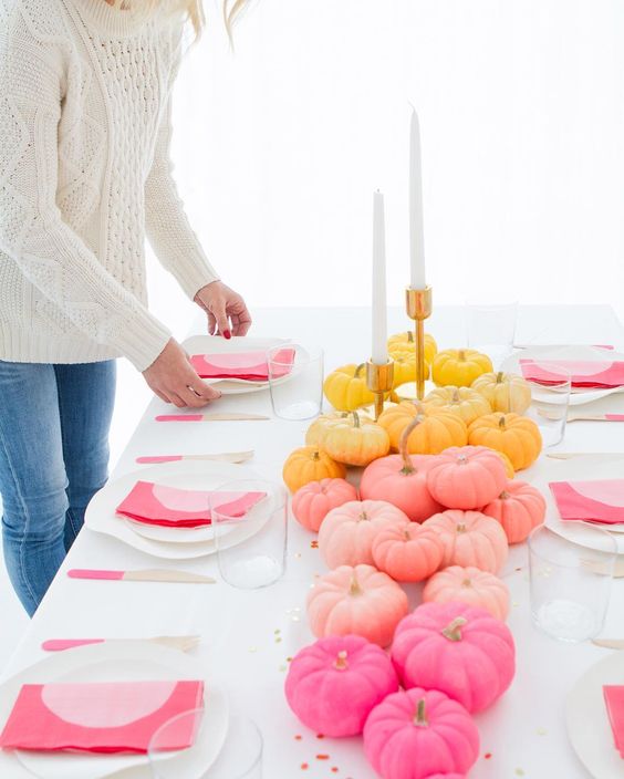 Table centerpiece with pumpkins and gray place settings
