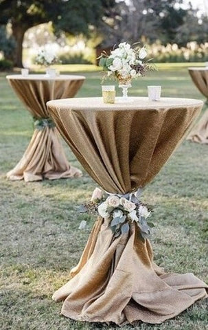 Rustic burlap-draped tall table outdoors