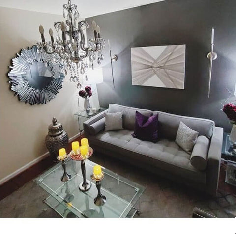 Pink candle holders on a dining table with a mirrored tray