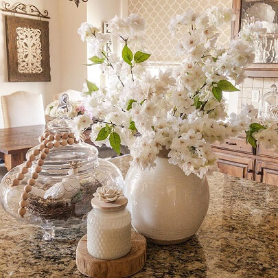 White floral arrangement in ceramic vase on kitchen counter