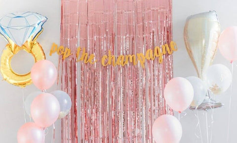 Pink fringe backdrop with balloons