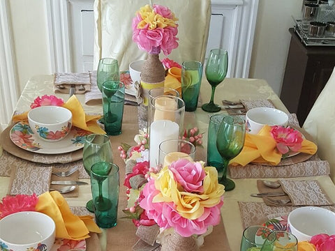Table setting with floral centerpiece and green goblets