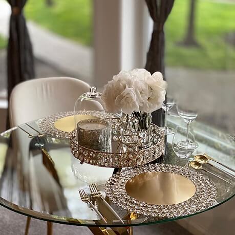 Round glass table with crystal candle holders and white florals