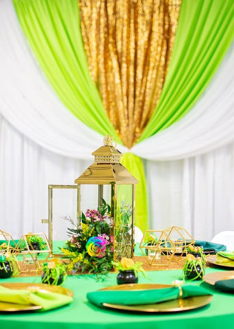 Gold vase with yellow flowers and matching candle holders
