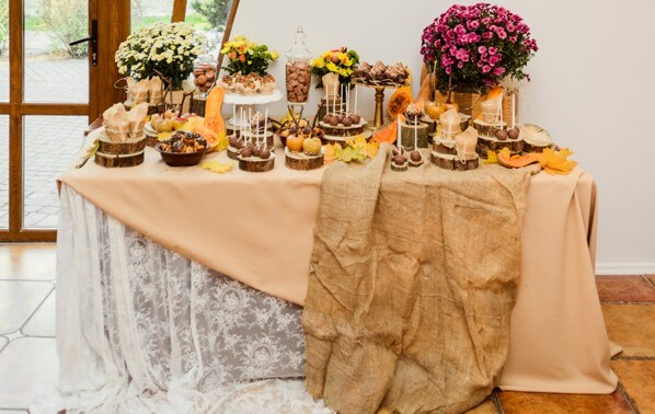 Fall table setting with flowers and gold glassware