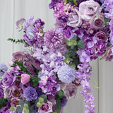 Purple floral arrangement featuring roses, hydrangeas, and other blooms. #whtbkgd
