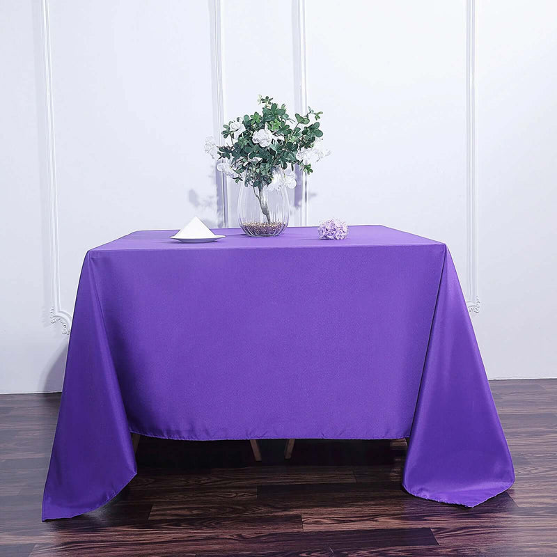 Purple tablecloth with floral centerpiece