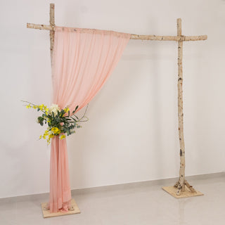 Wedding backdrop with pink drapery and floral arrangement
